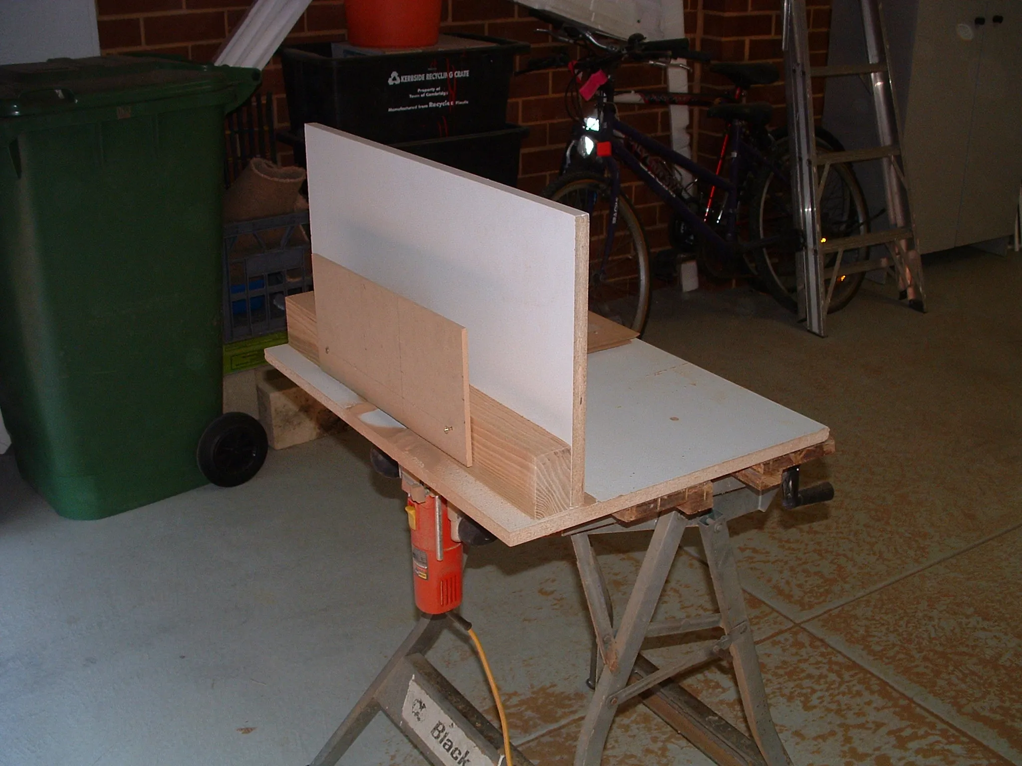 Lock miter joint routing: close-up of blade, fence, or panel position.