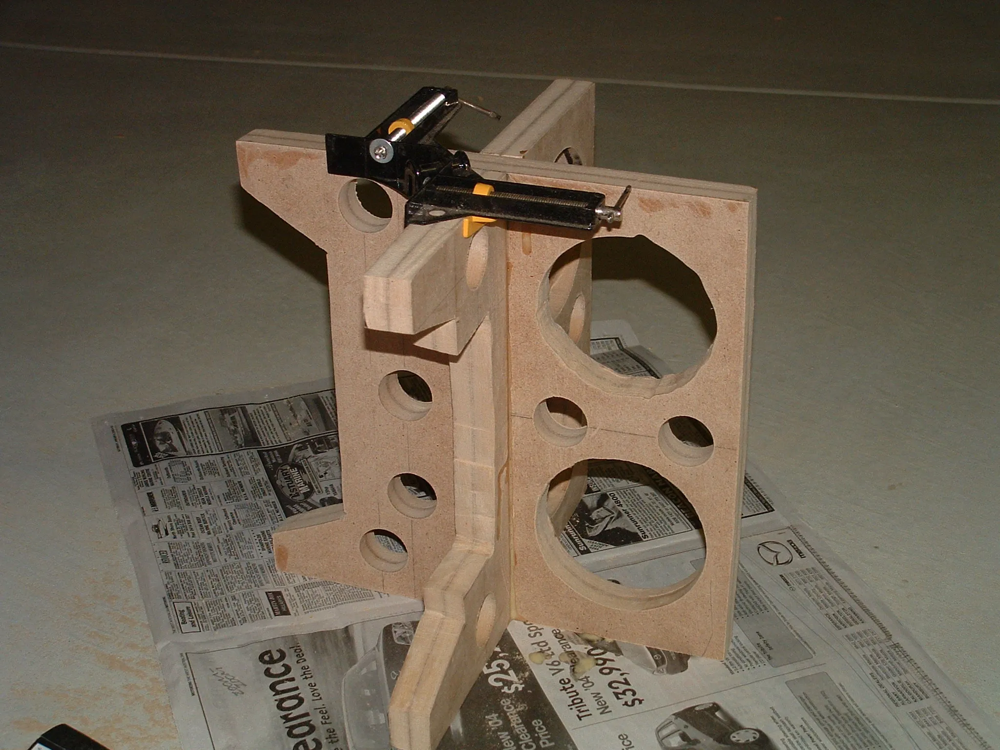 DIY subwoofer project: speaker cabinet with driver or cutout visible.